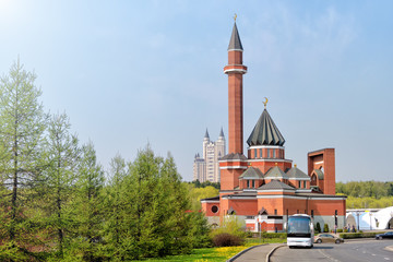 mosque modern street architecture in moscow city russia skyline side view of islam religion minaret building with spring time green park forest landscape scenic cityscape landmark blue sky background