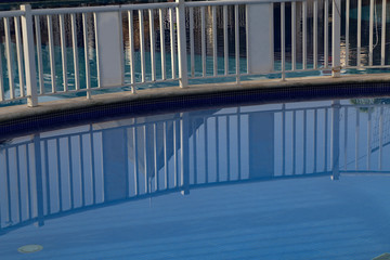 metal fence grill in the pool with blue water