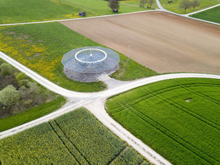 Aerial view by drone over the spring fields with a obsolete D-VOR (VHF omnidirectional radio range)...