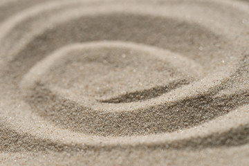 Fototapeta na wymiar concentric circles pattern on natural sand texture background