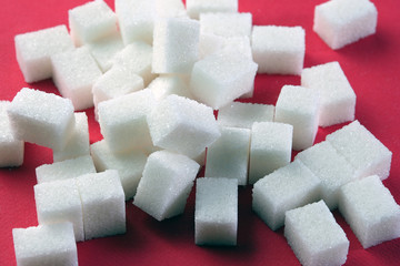 White lump sugar on a dark background.