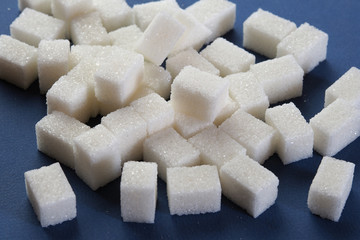 White lump sugar on a dark background.