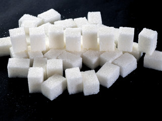 White lump sugar on a dark background
