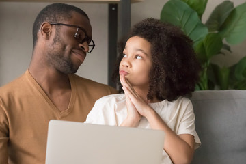 Daughter asking dad new toy or game in online store