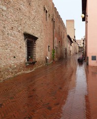 Wet brick street in Certaldo Alto, Italy