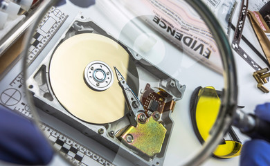 Police expert examines hard drive in search of evidence, conceptual image