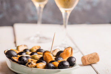 mussels on a plate as an appetizer to white wine