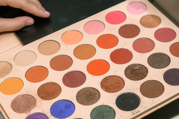 palette of shadows in the makeup artist's hand