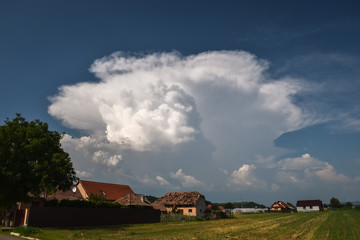 Classic example of a typical summer thunderstorm with updraft and anvil over the Carpathian mountains in Romania, eastern Europe.