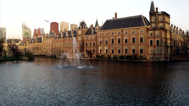 The Binnenhof in Den Haag in an aerial shot. The drone rises into the sky revealing the skyline with the skyscrapers.