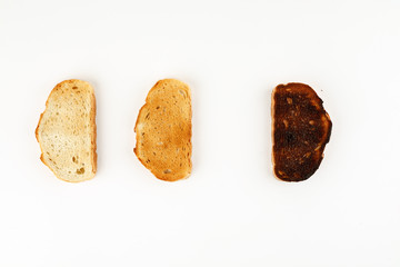 Three toasts in different stages of roasting, top view, text space