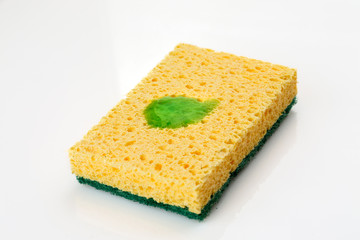 Yellow sponge with some cleaning green liquid on it