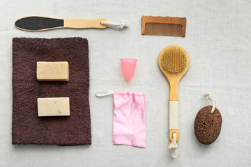 Natural bath accessories with menstrual cup on light background. Zero waste concept