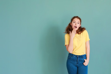 Shocked teenage girl on color background