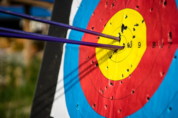 Close up on three arrows in the middle center of the target goal achieved success archery