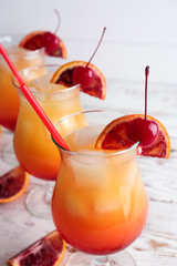 Glasses of Tequila Sunrise cocktail on table