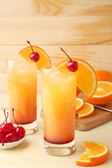 Glasses of tasty Tequila Sunrise cocktail on table