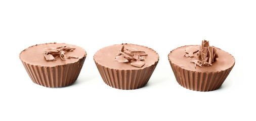 Tasty chocolate peanut butter cups on white background