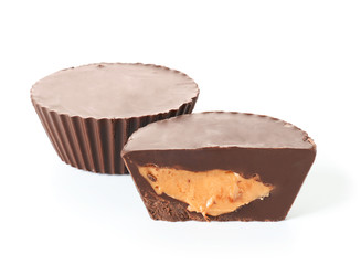 Tasty chocolate peanut butter cups on white background