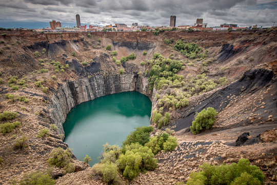 Wide view of The Big Hole in Kimberley, a result of the mining industry, with the town skyline on the edge