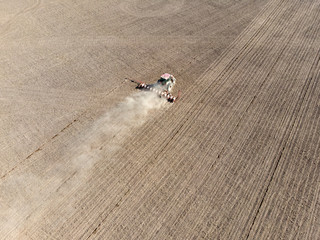 Aerial photo of a tractor ploughing a field in the countryside