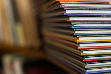 A stack of colorful books close up. A stack of multi-colored books close-up. View of the spine of...