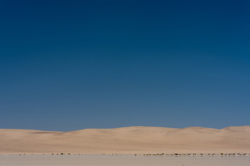 Fototapeta na wymiar Coastal Sand Dunes under a large blue sky near Walvis Bay, Namibia
