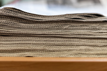 A stack of newspapers close-up. Lots of jagged paper sheets.