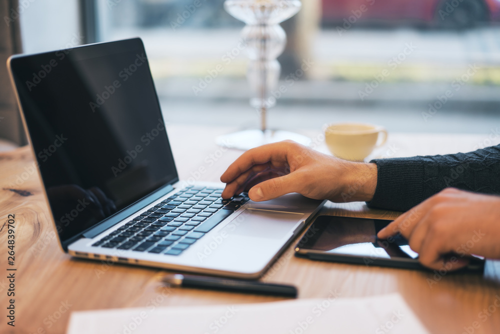 Poster man using empty laptop screen on desktop