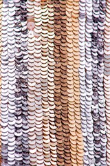 Fabric with sequins and sequins of bright colors. Fashion glitter fabric, sequins. Shiny surface