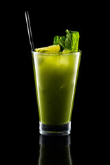 Glass of fresh cold smoothies with straw isolated on black