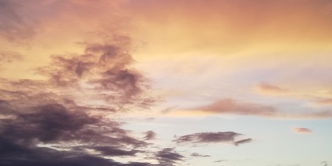 Stunning scenic backdrop. Multicolored clouds in the sunset sky. Light clouds contrast with dark clouds