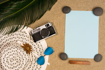 Summer vacation composition. Hat, palm leaves, sunglasses and vintage camera. Free space for your text