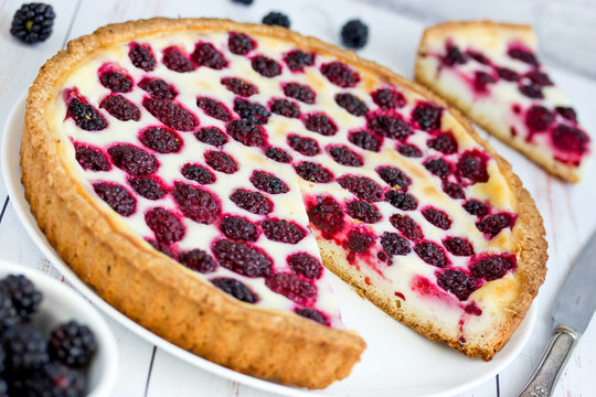 Blackberry sour cream pie - homemade tart summer pie with ripe blackberries berry and sour cream sweet filling on crispy thin dough