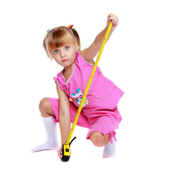 Little girl with a building tape measure.