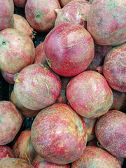 Big bulk pomegranates for sale in a grocery store