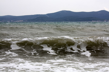 Adriatic Sea. Dalmatia. Landscape with waves and mountains on island.