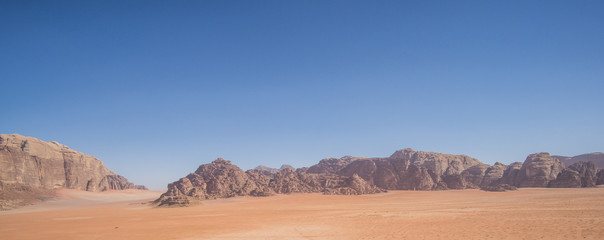 A beautiful day in the Jordanian desert of Wadi Rum. wide dessert with an amazing mountains and...