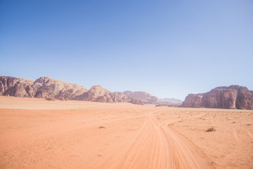 Fototapeta na wymiar A beautiful day in the Jordanian desert of Wadi Rum. wide dessert with an amazing mountains and sand dunes , amazing scenery that you should see ! 