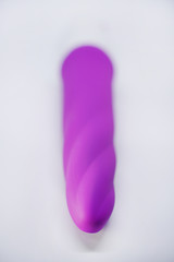 Bright sex toys on white background in the studio 