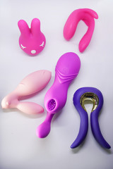 Bright sex toys on white background in the studio 