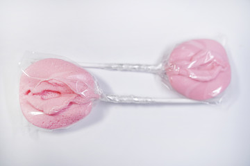 sexy lollipop candy in the form of the female sexual organ on a white background in the Studio....