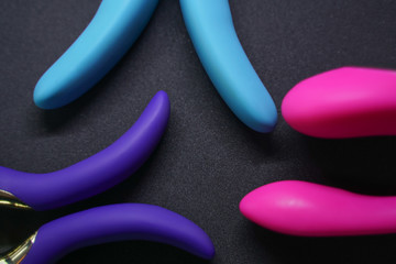 Bright sex toys on white background in the studio 
