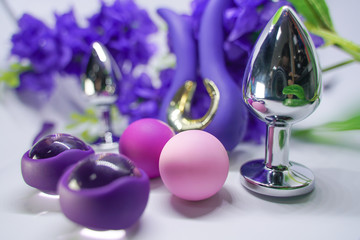 Bright sex toys on white background in the studio 