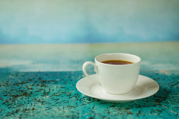 A cup of hot tea with different colours background.