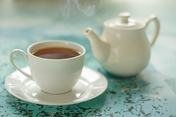 A cup of hot tea with different colours background.