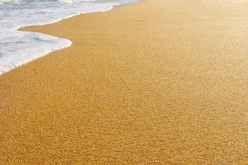 beach with golden sand and blue ocean water