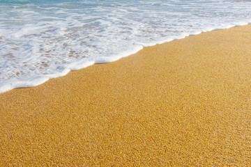 beach with golden sand and blue ocean water