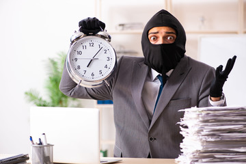 Male gangster stealing information from the office 