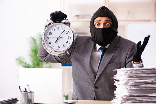 Male gangster stealing information from the office 
